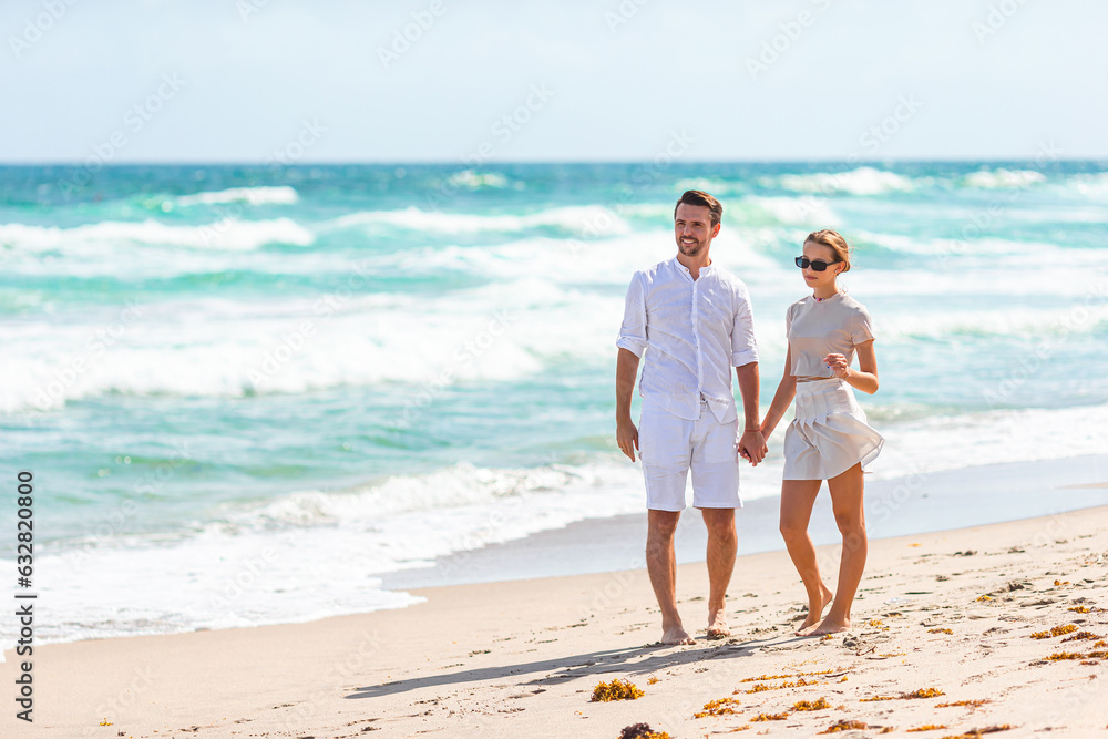 Adorable girl and happy dad having fun during beach vacation Adorable girl and happy dad having fun during beach vacation