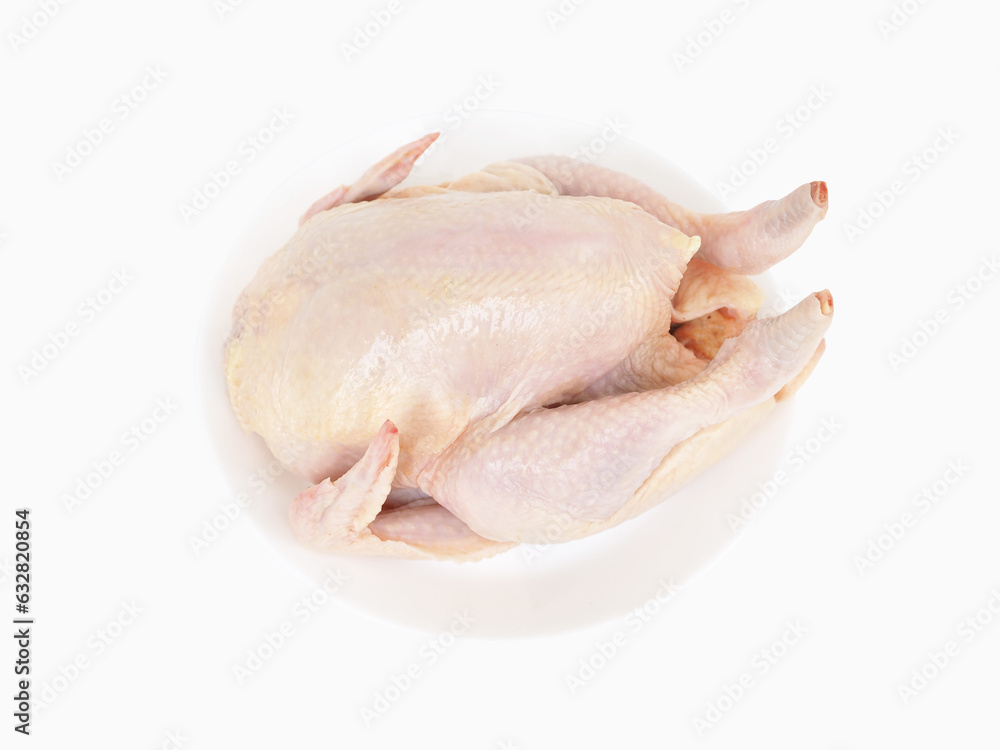 Whole raw chicken on dish isolated on white background. Whole raw chicken on dish isolated on white background.