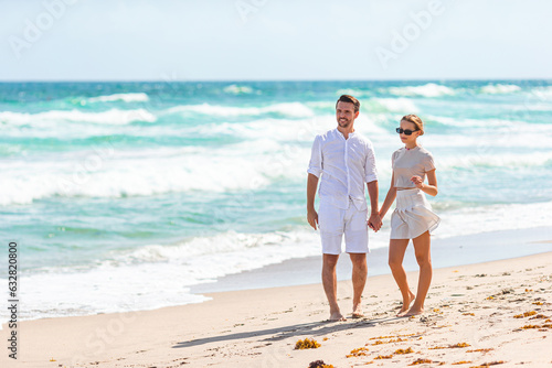 Adorable girl and happy dad having fun during beach vacation