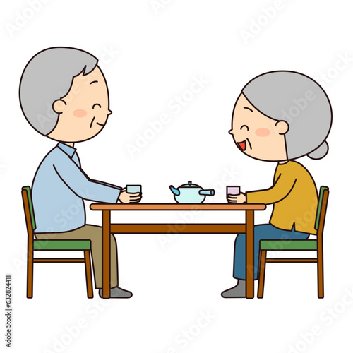 食卓で楽しく会話しながらお茶を飲んでいる老夫婦