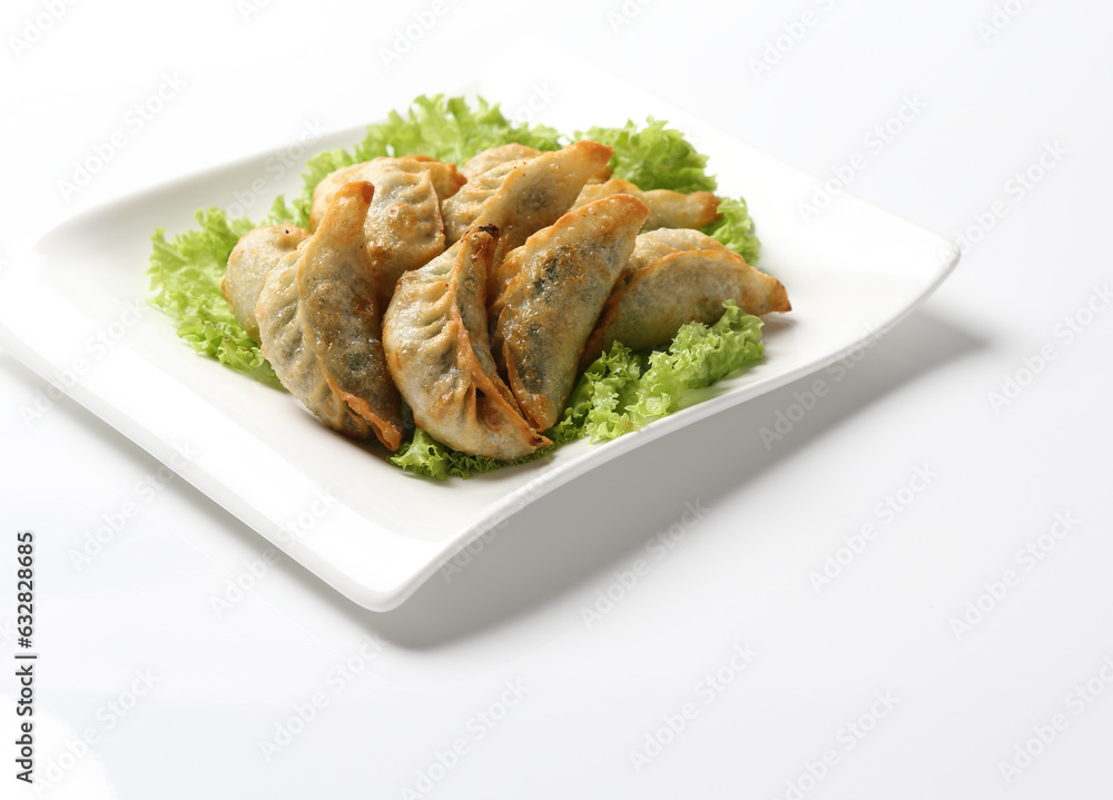 deep fried pork chicken dumpling guo tie jiaozi dim sum in plate on white background appetiser food snack halal menu for Hong Kong cafe deep fried pork chicken dumpling guo tie jiaozi dim sum in plate on white background appetiser food snack halal menu for Hong Kong cafe