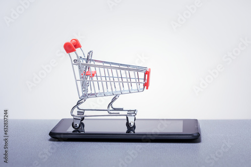 Online business and e-commerce or shopping online concept. shopping trolley over a tablet PC with place for text. © Sergey