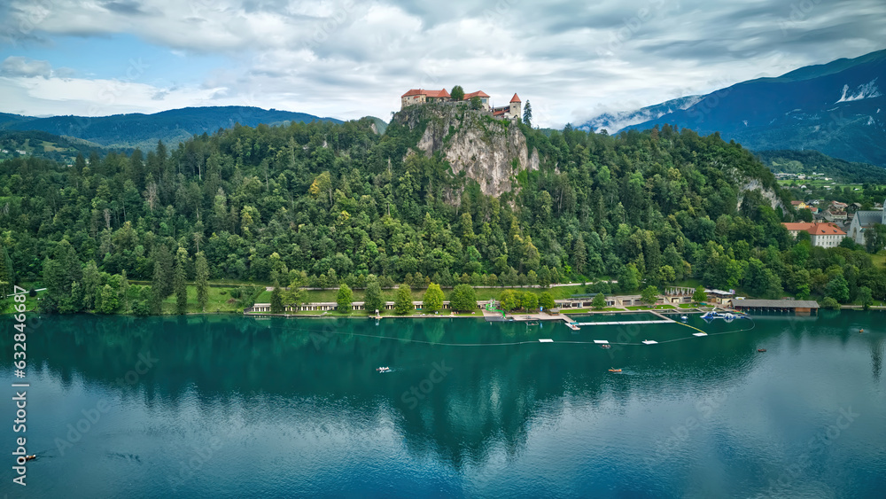 Aerial view of beautiful Bled Castle (Blejski Grad) with Lake Bled (Blejsko Jezero) on a bright summer day - Bled, Slovenia