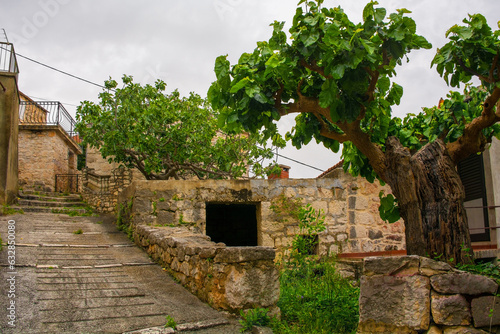 A street of historic stone houses in Loziscz Village in the centre of Brac Island in Croatia photo