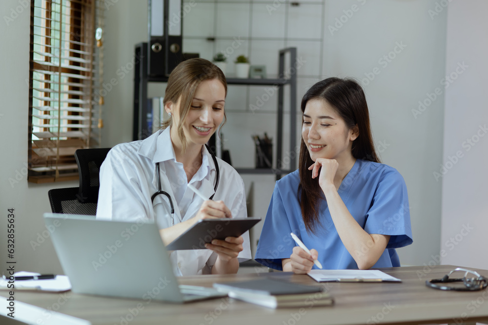 Two female doctor working at desk in clinic office, Teamwork in medicine and healthcare concept. Two female doctor working at desk in clinic office, Teamwork in medicine and healthcare concept.