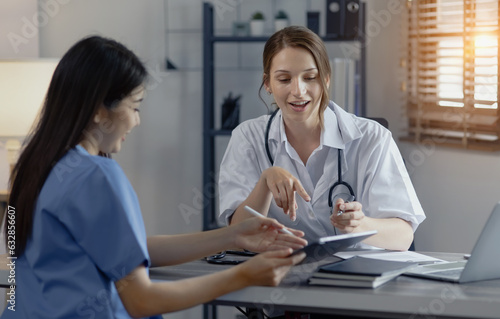 Wallpaper Mural Two female doctor working at desk in clinic office, Teamwork in medicine and healthcare concept.	 Torontodigital.ca