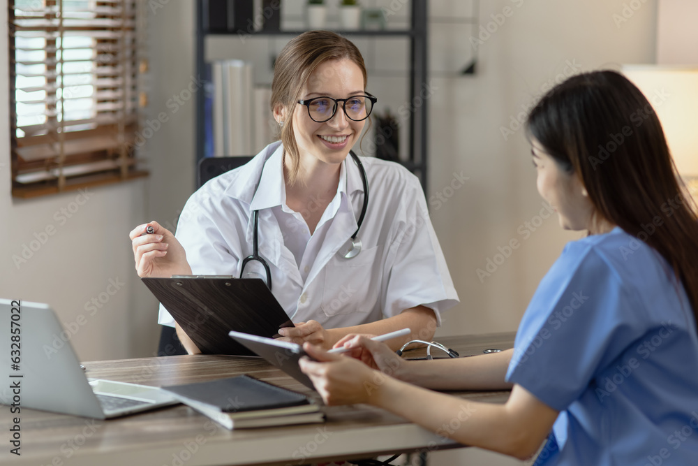 Two female doctor working at desk in clinic office, Teamwork in medicine and healthcare concept.	