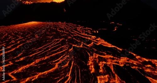 Epic FPV drone shot really close to glowing lava at a erupting volcano basin photo