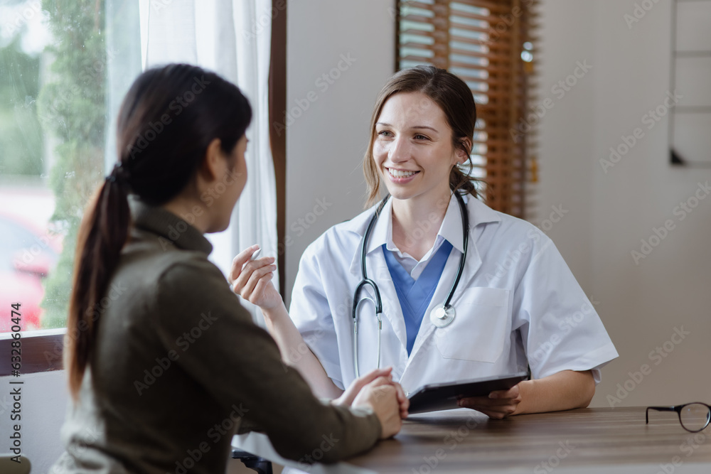 female doctor with female patient and telling advices sitting at workplace in clinic office, Healthcare and medical concept. female doctor with female patient and telling advices sitting at workplace in clinic office, Healthcare and medical concept.