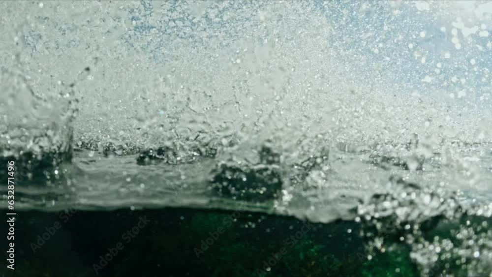 water crashes to rock , underwater and above view water crashes to rock , underwater and above view