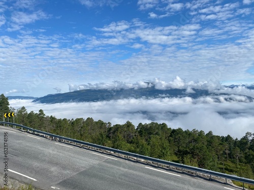 Road View near Skei, Norway with lake covered by clouds
