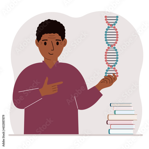 A man holds a DNA model in his hand and there are many books nearby.