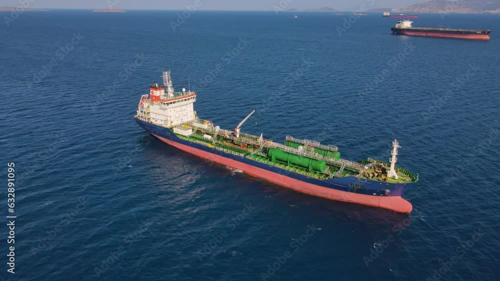 Aerial top down view of oil chemical tanker ship anchored in sea industrial port area Aerial top down view of oil chemical tanker ship anchored in sea industrial port area