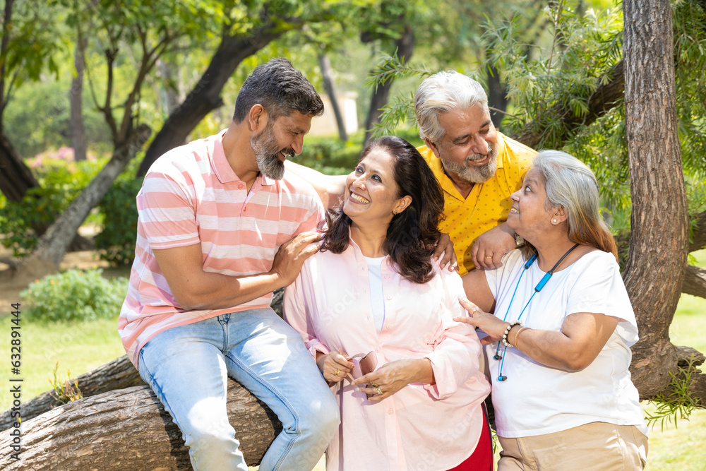 Fototapeta premium Indian family giving happy expression at park.