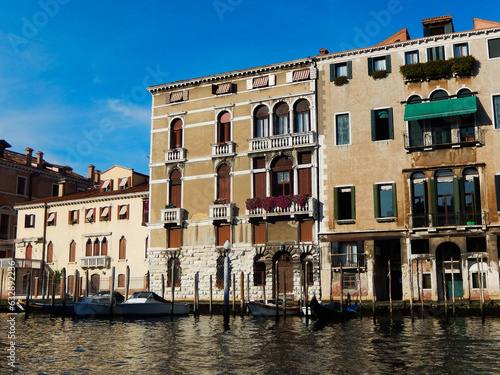 Old and historical Venetian houses with canal waterfront landscape and moored modern boats in Venice Italy © Voyage View Media