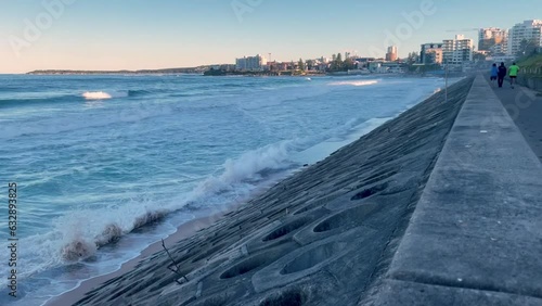 HD Video- Waves crashing on the sea wall at North Cronulla Beach, Sydney, Australia. Due to coastal erosion and following a storm (June 2022) sand was ripped from the beach and ocean reached sea-wall. photo