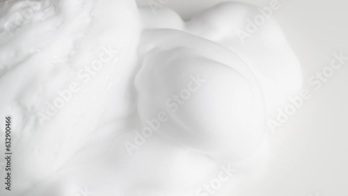 Hair foam mousse, macro. Beauty background. Close up of white cloud of hair mousse or shaving foam.
