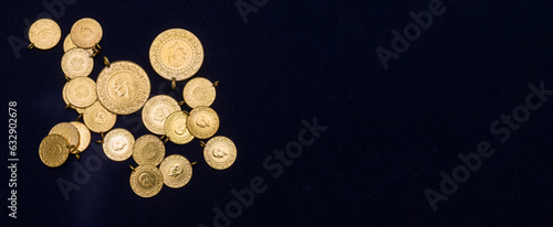 Принти на полотні The pile of full, half and quarter Turkish gold coins on a dark navy blue backgr