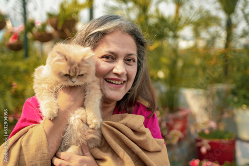 Indian senior woman with cat at home photo