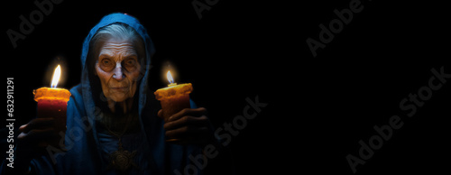 Old gnarly Witch looking scary or creepy while holding two candles in the dark. Halloween banner with copy space.