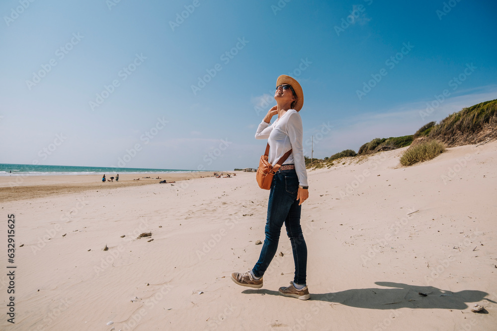 Beautiful woman enjoying nice weather on the beach, blue sky, clean sand in Playa de la Ballena Spain Europe Beautiful woman enjoying nice weather on the beach, blue sky, clean sand in Playa de la Ballena Spain Europe