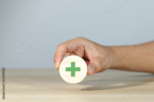 Foto Wooden blocks showing plus and minus signs