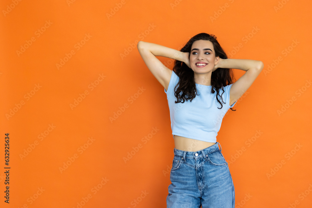 Photo portrait of female f smiling with folded hands on bright orange color background