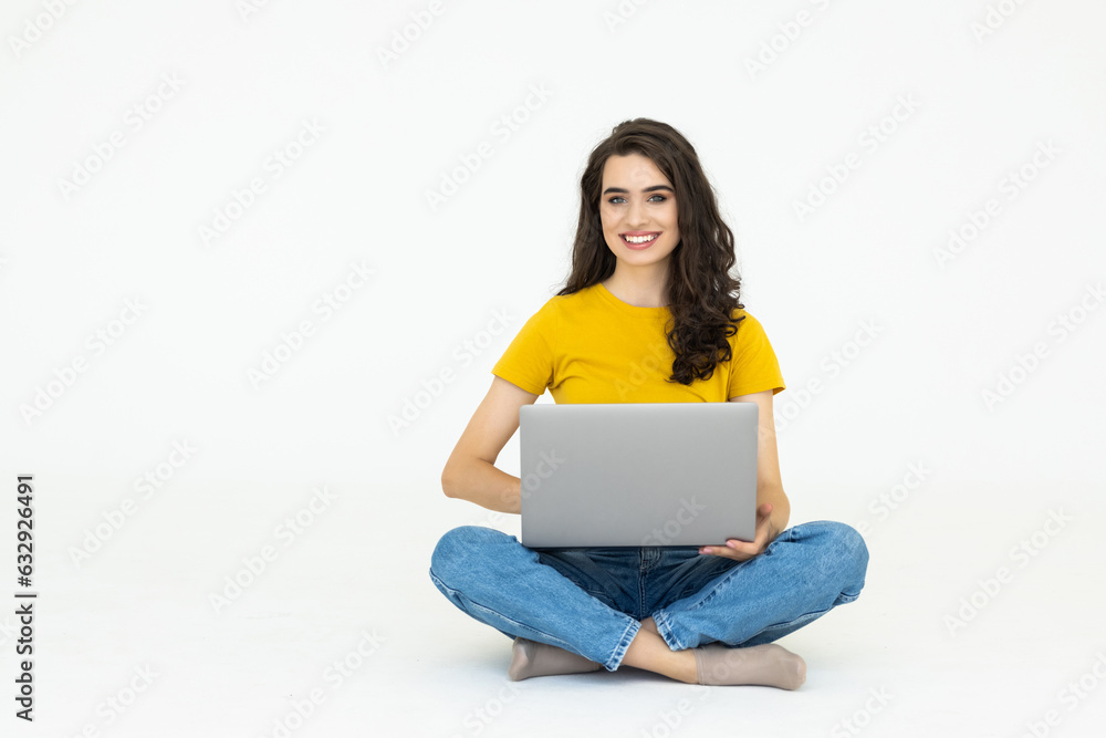 Happy woman sitting on the floor and using laptop on white background Happy woman sitting on the floor and using laptop on white background