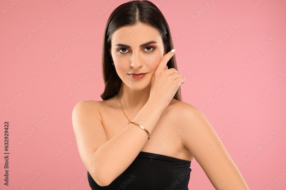 Beautiful woman with elegant jewelry on pink background Beautiful woman with elegant jewelry on pink background
