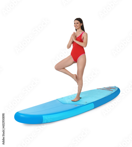 Happy woman practicing yoga on blue SUP board against white background