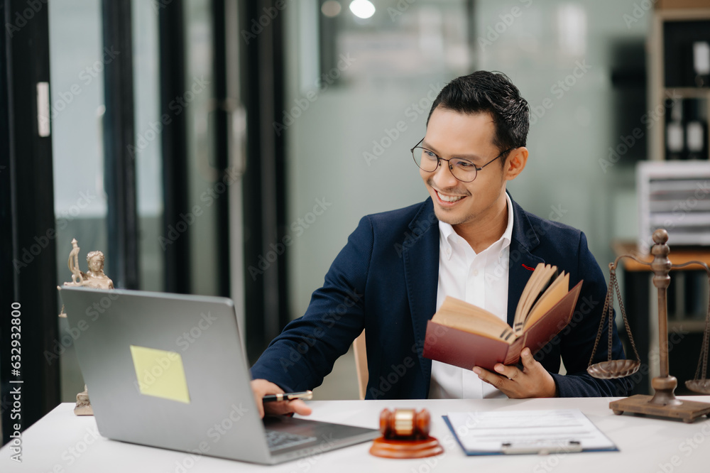 Man lawyer reading legal book with gavel on table in office. justice and law ,attorney concept... Man lawyer reading legal book with gavel on table in office. justice and law ,attorney concept...
