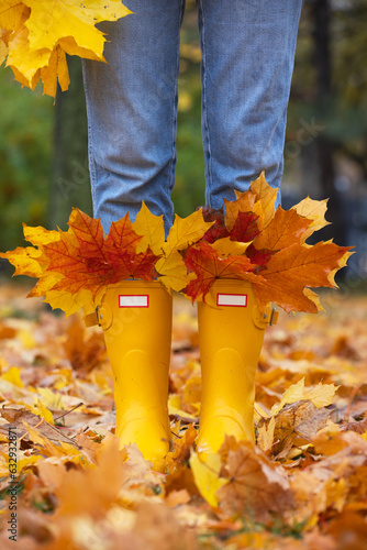 bright autumn. girl in yellow rubber boots walking