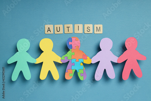 Paper figures of people on a light background. World autism day concept photo