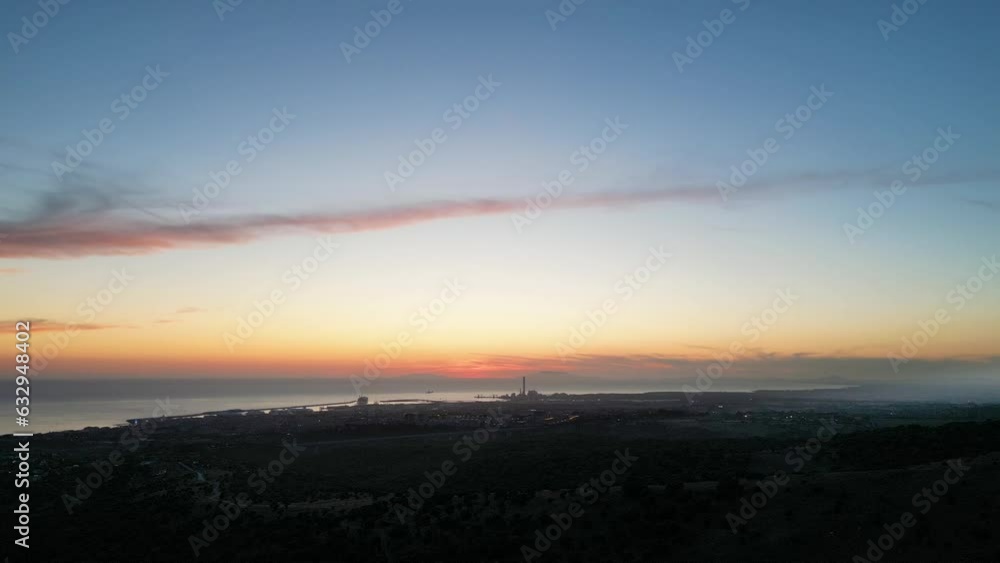 Italian city landscape. Civitavecchia at sunset between smog and fog. Italian city landscape. Civitavecchia at sunset between smog and fog.