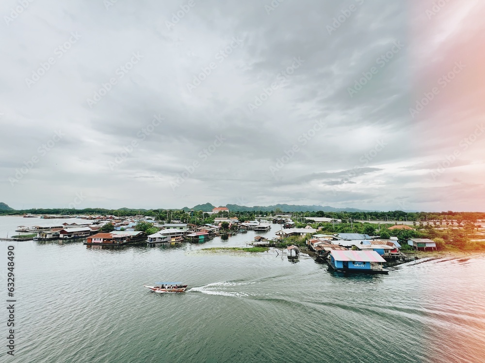Fototapeta premium Thailand style boat on the river with floating old town