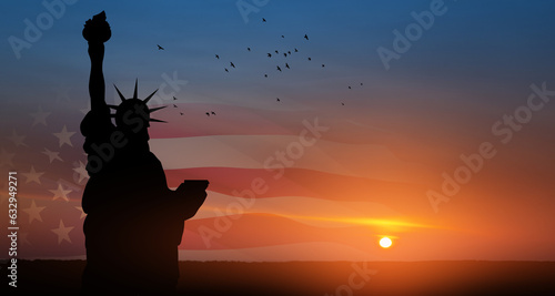 Statue of Liberty with American flag and flying birds on background of sunset sky. Close-up. Greeting card for Independence Day. USA celebration.