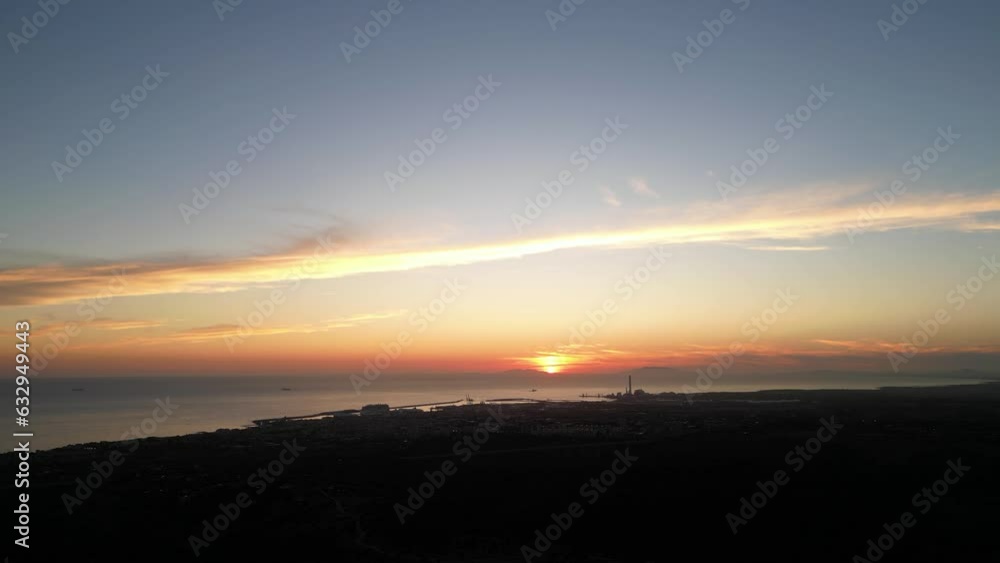 Italian city landscape. Civitavecchia at sunset between smog and fog. Italian city landscape. Civitavecchia at sunset between smog and fog.