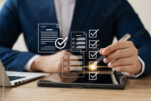 Tablou canvas Business performance monitoring concept, businessman using tablet and laptop Online survey filling out, digital form checklist, blue background