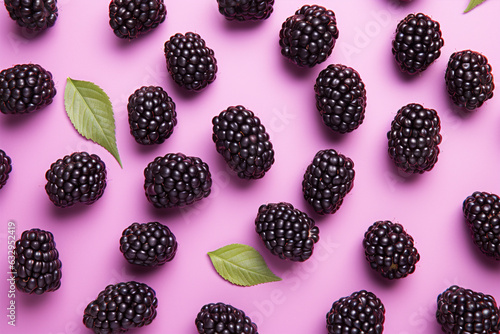 Top view of blackberry fruits on pink background