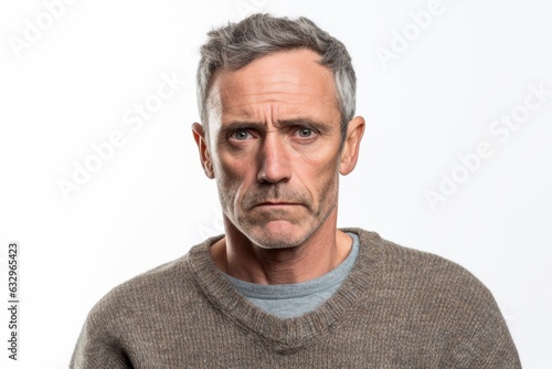 Group portrait photography of a man in his 40s with furrowed brows and a tense expression due to hypertension wearing a cozy sweater against a white background 