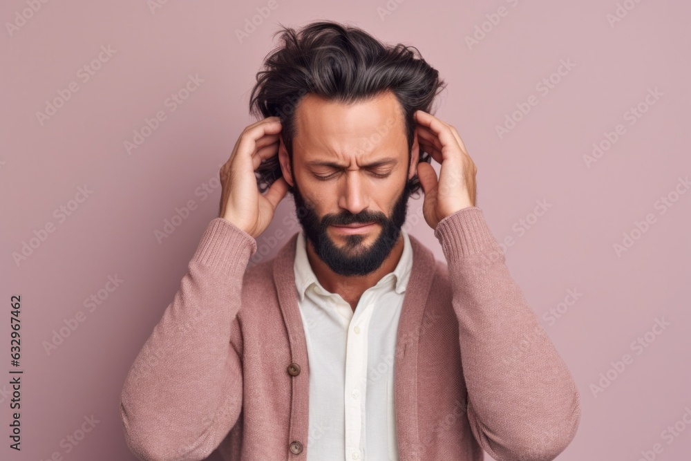 Medium shot portrait photography of a man in his 30s pressing his temple due to a migraine wearing a chic cardigan against a pastel or soft colors background Medium shot portrait photography of a man in his 30s pressing his temple due to a migraine wearing a chic cardigan against a pastel or soft colors background