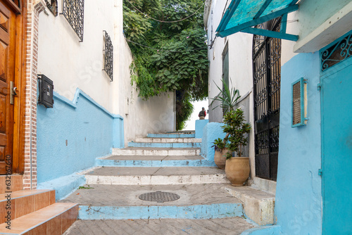 Narrow alley with stairs and houses painted blue and white at Ksbah, Ancient Medina, Tangier, Morocco
