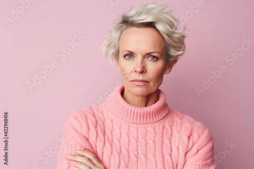 Medium shot portrait photography of a woman in her 40s appearing weakened and pale because of anemia wearing a cozy sweater against a pastel or soft colors background 
