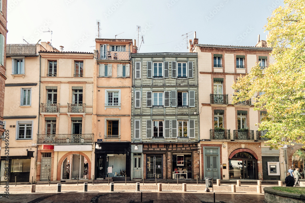 Facade or exterior of historic traditional houses in the old city of Toulouse, France