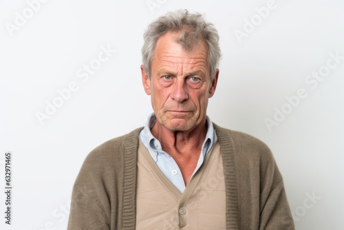 Group portrait photography of a man in his 50s with a pained and tired expression due to fibromyalgia wearing a chic cardigan against a white background 