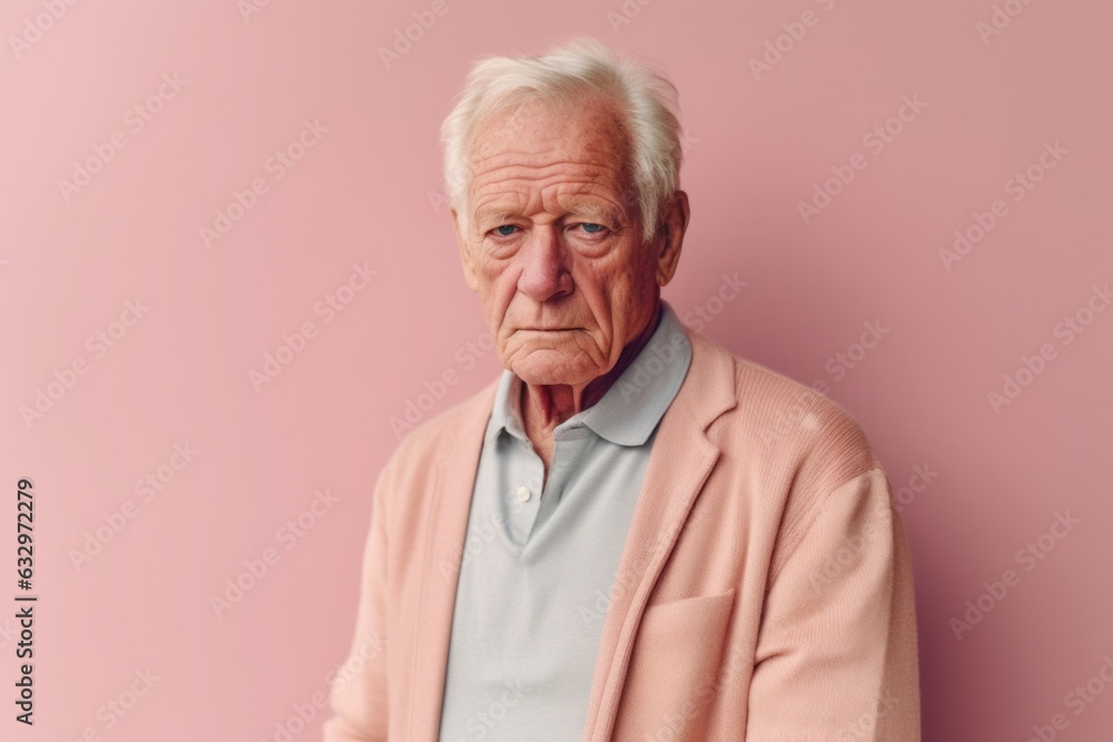 Close-up portrait photography of a man in his 70s with a hint of fatigue due to chronic kidney disease wearing a chic cardigan against a pastel or soft colors background Close-up portrait photography of a man in his 70s with a hint of fatigue due to chronic kidney disease wearing a chic cardigan against a pastel or soft colors background