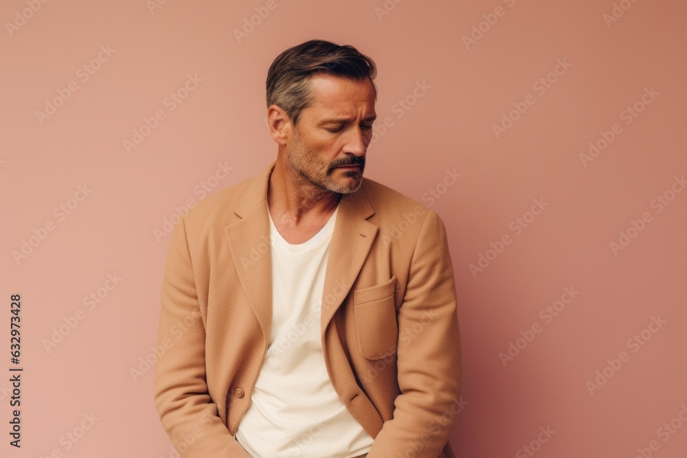 Medium shot portrait photography of a man in his 40s appearing tired and down due to hypothyroidism wearing a chic cardigan against a pastel or soft colors background Medium shot portrait photography of a man in his 40s appearing tired and down due to hypothyroidism wearing a chic cardigan against a pastel or soft colors background