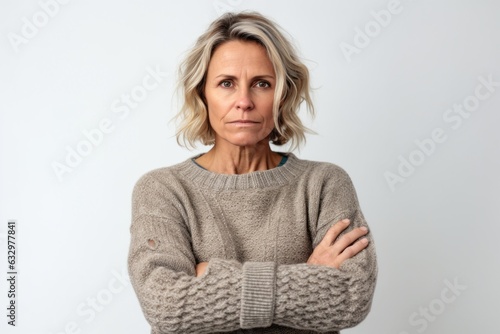 Lifestyle portrait photography of a woman in her 40s with a somber and deeply sad expression due to major depression wearing a cozy sweater against a white background 