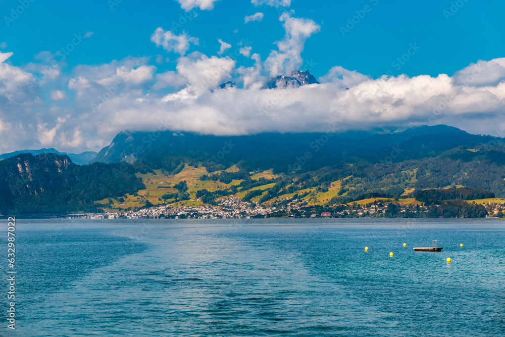 Lovely scenic view from Lake Lucerne of the town Horw and the famous Mount Pilatus in the back. Horw is a municipality in the district of Lucerne in the canton of Lucerne in Switzerland.