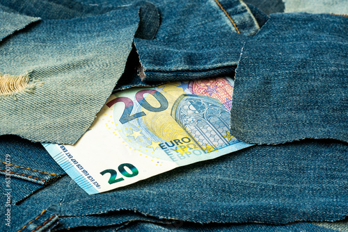 Twenty euro euro banknote in the pile of discarded old blue jean scrap